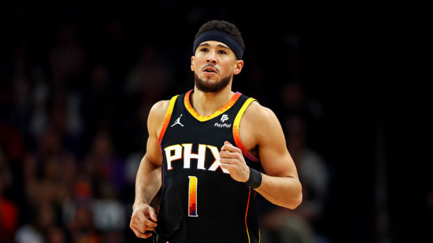 Phoenix Suns guard Devin Booker (1) runs up the court during the first quarter against the Milwaukee Bucks at Footprint Center.